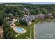 Aerial view showcasing the waterfront home at 7600 Dunsmir Court, complete with a pool and lush landscaping at 7600 Dunsmuir Ct, Cornelius, NC 28031