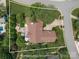 Aerial view of a home with approximate property lines showing its location, landscaping, and surrounding neighborhood at 7600 Dunsmuir Ct, Cornelius, NC 28031