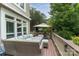 Spacious backyard deck with plush seating, a dining area, and a large umbrella for shade at 7600 Dunsmuir Ct, Cornelius, NC 28031