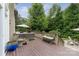 Expansive backyard deck with comfortable seating, a charming fountain, and lush landscaping at 7600 Dunsmuir Ct, Cornelius, NC 28031