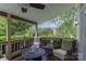 Relaxing screened porch area with comfortable seating overlooking lush greenery at 7600 Dunsmuir Ct, Cornelius, NC 28031