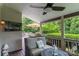 Inviting back porch with wicker seating, ceiling fan, and view of a lush backyard at 7600 Dunsmuir Ct, Cornelius, NC 28031