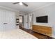 Cozy bedroom featuring hardwood floors, natural light, and ensuite bath at 7600 Dunsmuir Ct, Cornelius, NC 28031