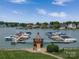 Picturesque view of a community boat dock with multiple boats docked, set against a backdrop of waterfront homes at 7600 Dunsmuir Ct, Cornelius, NC 28031