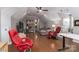 Large bonus room features sloped ceilings, hardwood floors, and a variety of comfortable seating at 7600 Dunsmuir Ct, Cornelius, NC 28031