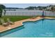 Inviting community pool with clear blue water, lounge chairs and views of the lake for relaxation and enjoyment at 7600 Dunsmuir Ct, Cornelius, NC 28031