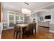 Bright dining room with large windows, plantation shutters, and elegant lighting at 7600 Dunsmuir Ct, Cornelius, NC 28031