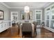 Beautiful dining room featuring hardwood floors, elegant lighting, and access to other living spaces at 7600 Dunsmuir Ct, Cornelius, NC 28031