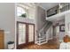 Elegant foyer with soaring ceilings, hardwood floors, and a grand staircase at 7600 Dunsmuir Ct, Cornelius, NC 28031
