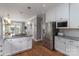 Bright kitchen with granite countertops, stainless steel appliances, hardwood floors, and white cabinetry at 7600 Dunsmuir Ct, Cornelius, NC 28031