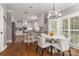 Eat-in kitchen with white cabinets, granite counters, stainless appliances and pendant lighting at 7600 Dunsmuir Ct, Cornelius, NC 28031