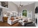 Cozy living room featuring high ceilings, hardwood floors, and seamless flow to dining area at 7600 Dunsmuir Ct, Cornelius, NC 28031