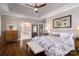 Serene main bedroom with tray ceilings, hardwood floors, and an ensuite bathroom at 7600 Dunsmuir Ct, Cornelius, NC 28031
