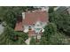 Aerial view of a home's rear exterior with a deck, outdoor seating, and lush landscaping, creating a private outdoor space at 7600 Dunsmuir Ct, Cornelius, NC 28031