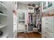 Spacious walk-in closet with custom shelving, drawers, and window for natural light at 7600 Dunsmuir Ct, Cornelius, NC 28031