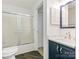 Clean bathroom with a tub, shower, and a vanity with storage and modern fixtures at 8183 Cedar Glen Dr, Charlotte, NC 28212