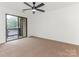 Bedroom with carpet, ceiling fan, and sliding glass door to balcony at 8183 Cedar Glen Dr, Charlotte, NC 28212