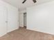 A bright bedroom featuring neutral carpet, ceiling fan, and closet at 8183 Cedar Glen Dr, Charlotte, NC 28212