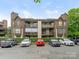 Exterior view of the building featuring multiple balconies and assigned parking spots at 8183 Cedar Glen Dr, Charlotte, NC 28212