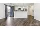 Modern kitchen with white cabinets, stainless steel appliances, and breakfast bar overlooking the dining area at 8183 Cedar Glen Dr, Charlotte, NC 28212