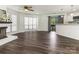 Open concept living room with wood floors, fireplace, and access to kitchen and balcony at 8183 Cedar Glen Dr, Charlotte, NC 28212