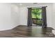Living room featuring dark wood floors and a sliding glass door to the balcony at 8183 Cedar Glen Dr, Charlotte, NC 28212