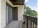 A private balcony with wooden planks, railings and a storage closet offers outdoor enjoyment at 8202 Cedar Glen Dr, Charlotte, NC 28212