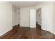 Bright bedroom with hardwood floors, multiple closets, and entry to a bathroom at 8202 Cedar Glen Dr, Charlotte, NC 28212