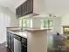 A partial view of the kitchen that overlooks the living room with a cozy fireplace at 8202 Cedar Glen Dr, Charlotte, NC 28212