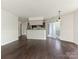Open living and kitchen space with hardwood floors and access to the private balcony at 8202 Cedar Glen Dr, Charlotte, NC 28212