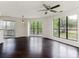 A sun-filled living room boasts new windows, ceiling fan, and sliding glass door to the outside at 8202 Cedar Glen Dr, Charlotte, NC 28212