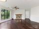 Bright living room with fireplace, ceiling fan, and large windows overlooking a treed front yard at 8202 Cedar Glen Dr, Charlotte, NC 28212