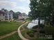 Manicured lawn with waterfront views, a pier, and community pool at 854 Southwest Dr, Davidson, NC 28036