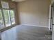 Bright empty bedroom with large windows and modern flooring at 854 Southwest Dr, Davidson, NC 28036