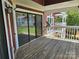 Spacious covered deck with wood flooring and an amazing exterior view at 854 Southwest Dr, Davidson, NC 28036