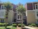 Inviting multi-story condo building with well-maintained landscaping and covered entryways at 854 Southwest Dr, Davidson, NC 28036