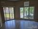 Sun-filled living room features large windows with lake views and sliding glass doors at 854 Southwest Dr, Davidson, NC 28036
