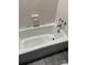 Classic white bathtub with vintage faucet fixtures in a tiled bathroom at 921 Nottingham Dr # 6, Gastonia, NC 28054