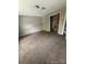 A carpeted bedroom featuring a closet with wood-paneled doors, offering ample storage at 921 Nottingham Dr # 6, Gastonia, NC 28054