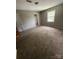 Spacious carpeted bedroom with natural light and a neutral color palette at 921 Nottingham Dr # 6, Gastonia, NC 28054