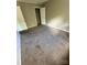 A bedroom with neutral walls and carpet flooring, featuring a closet and ample space at 921 Nottingham Dr # 6, Gastonia, NC 28054