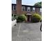 Traditional brick condo with a red door, decorative shutters, and mature landscaping at 921 Nottingham Dr # 6, Gastonia, NC 28054
