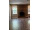 Living area showcasing a brick fireplace, complemented by natural light from the surrounding windows at 921 Nottingham Dr # 6, Gastonia, NC 28054