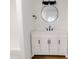 Modern bathroom with white vanity, updated fixtures, and a stylish round mirror at 940 N New Hope Rd, Gastonia, NC 28054