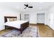 Primary bedroom with a ceiling fan, wood floors, and walk-in closets at 940 N New Hope Rd, Gastonia, NC 28054