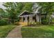 Charming home featuring a welcoming front porch and beautifully landscaped front yard with mature trees at 940 N New Hope Rd, Gastonia, NC 28054