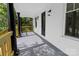 Close up on front porch with black columns, wood railings, and front door at 940 N New Hope Rd, Gastonia, NC 28054