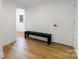 Hallway with wood flooring and a black bench at 940 N New Hope Rd, Gastonia, NC 28054