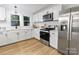 Bright kitchen features stainless steel appliances, white cabinets, and updated countertops at 940 N New Hope Rd, Gastonia, NC 28054