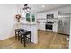 Stylish kitchen featuring white cabinetry, stainless steel appliances, and an eat-in breakfast bar with seating at 940 N New Hope Rd, Gastonia, NC 28054